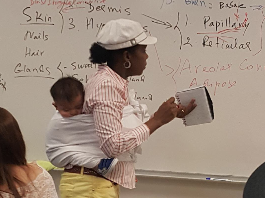 Georgia Professor Holds Student’s Baby, A Life Lesson Bundled On Her Back
